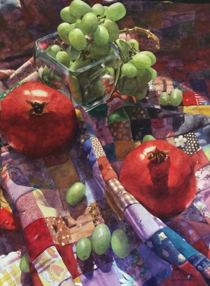 Pomegranates and grapes on blanket